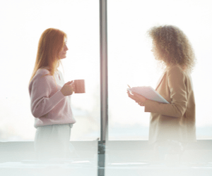 Women on either side of a mirror